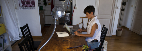 A woman consulting her laptop at home