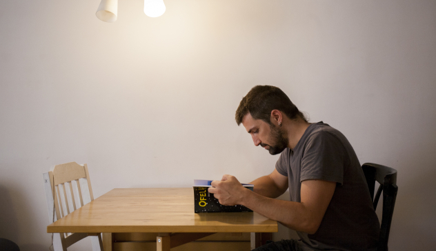 A man reading a book at a table